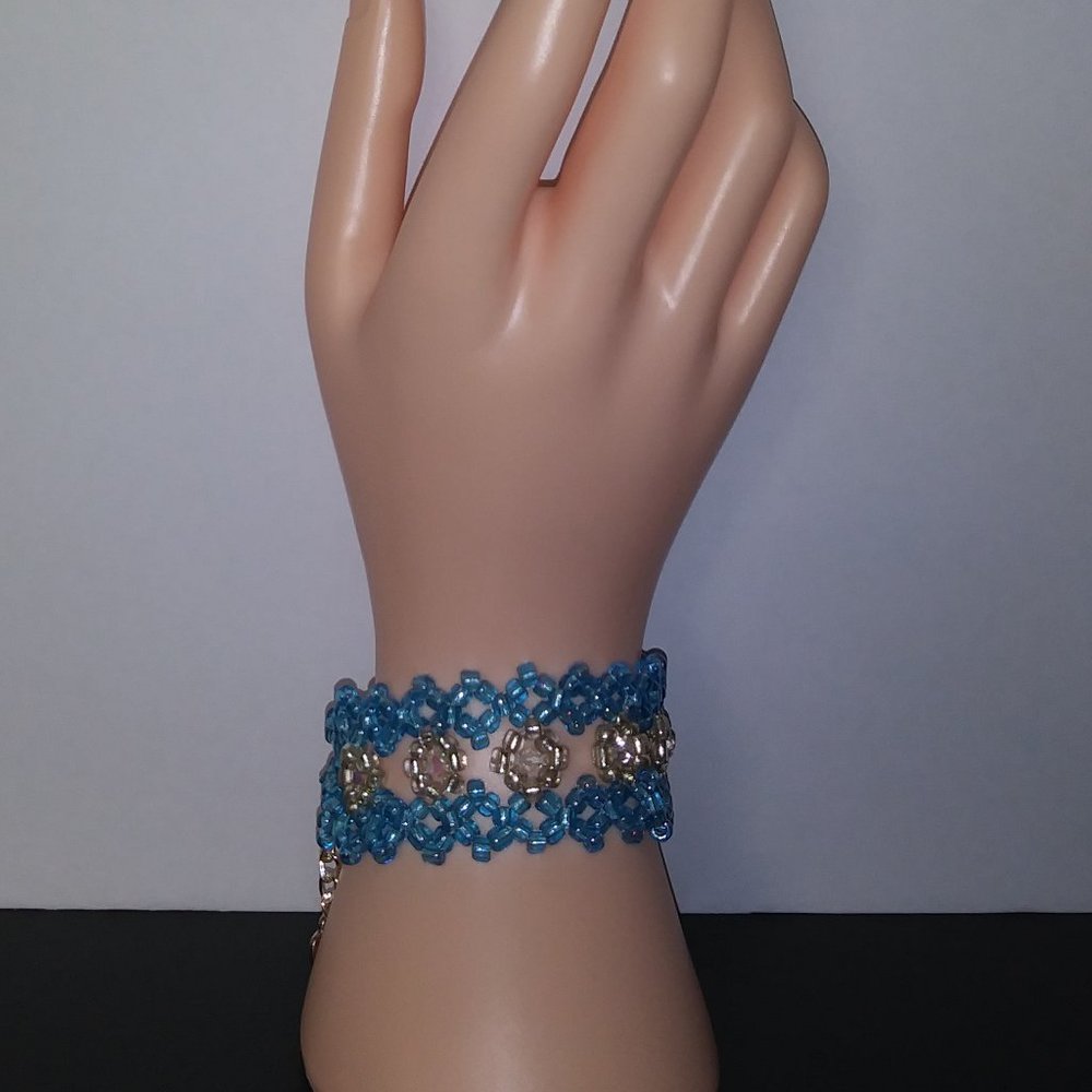 Handmade bracelet with beads in shades of water blue and white.